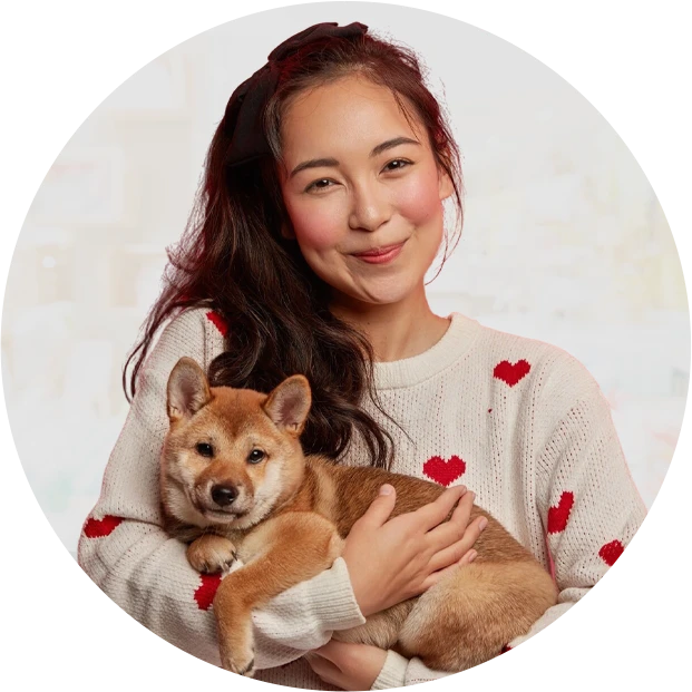 Pretty asian housewife carries pedigree dog hands expresses love pet